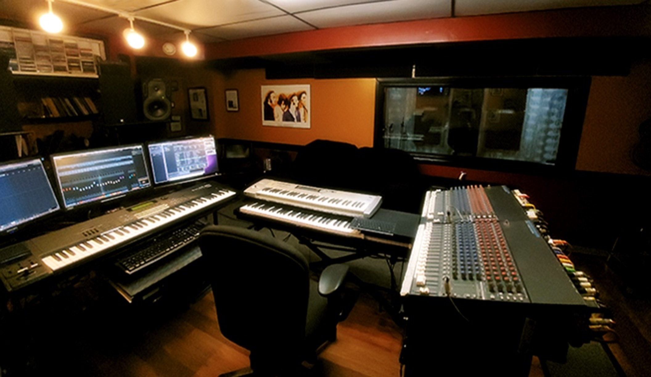 Control room with keyboards, monitors and mixing console