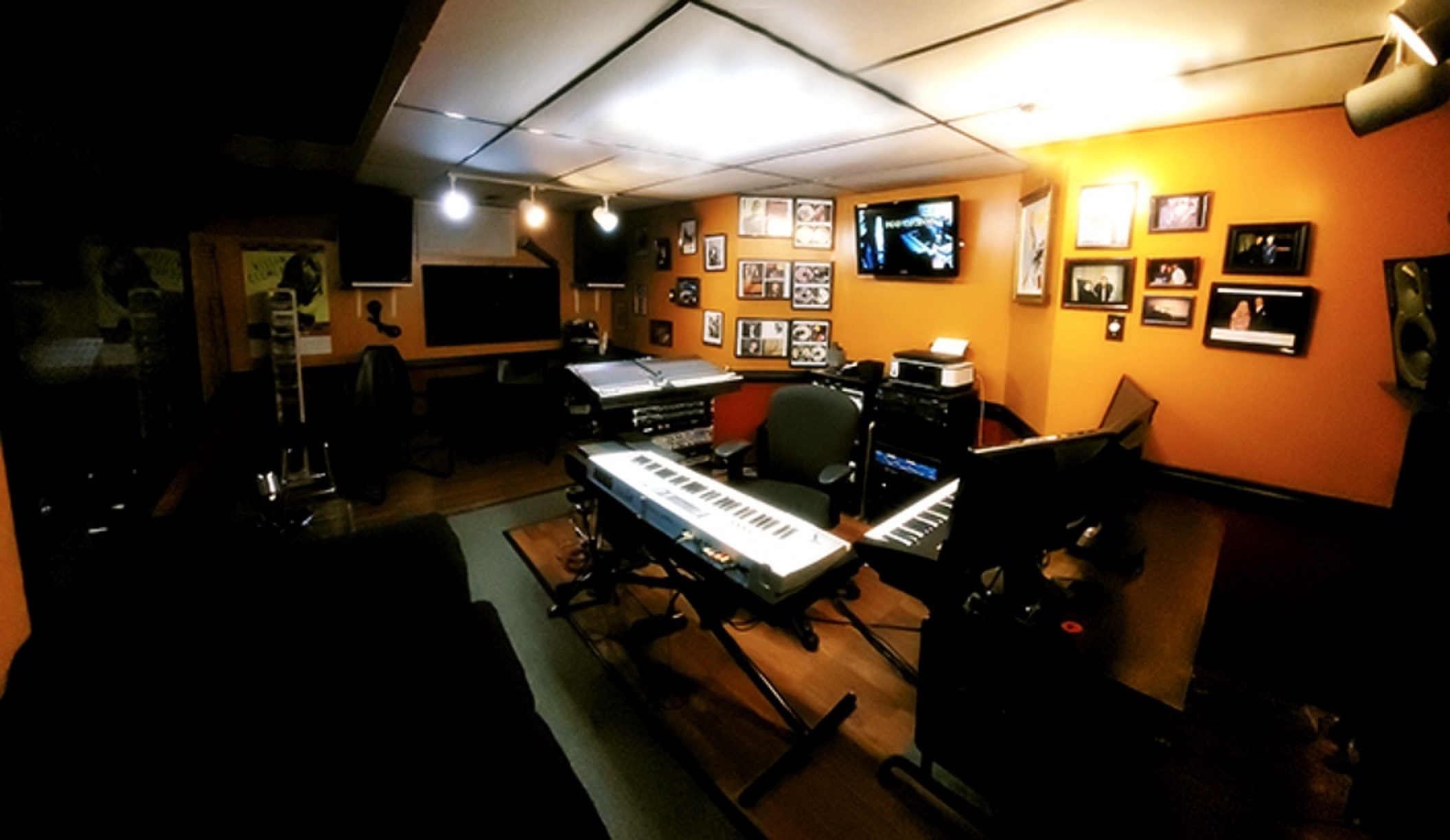 Control room with the Korg keyboard and wall of records